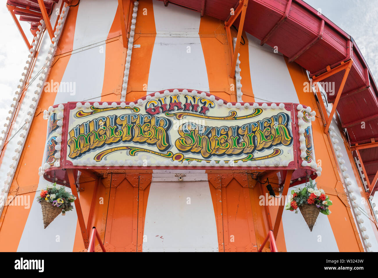 A sign on a vintage wooden helter skelter at a fair Stock Photo
