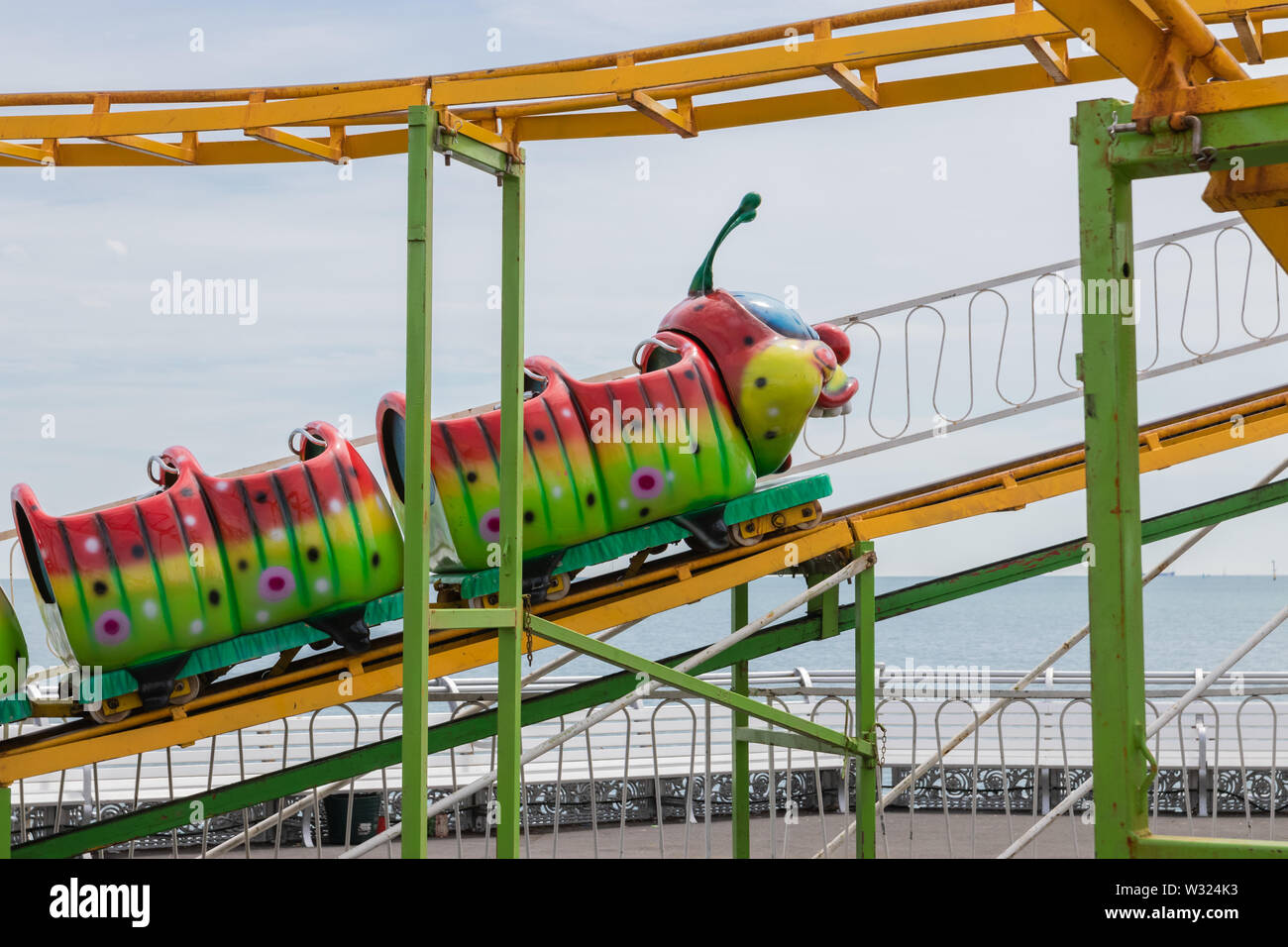 A child's caterpillar roller coaster at a funfair Stock Photo