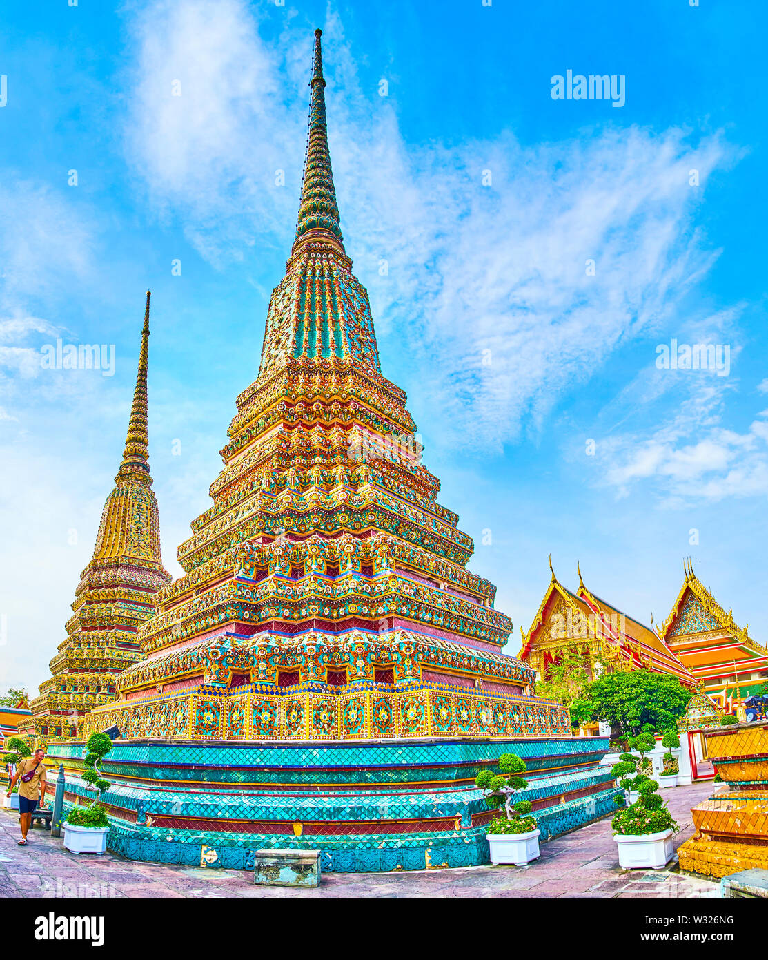 BANGKOK, THAILAND - APRIL 22, 2019: The beautiful stupas, covered with colorful glazed tiles of Phra Maha Chedi shrine are one of the most notable lan Stock Photo