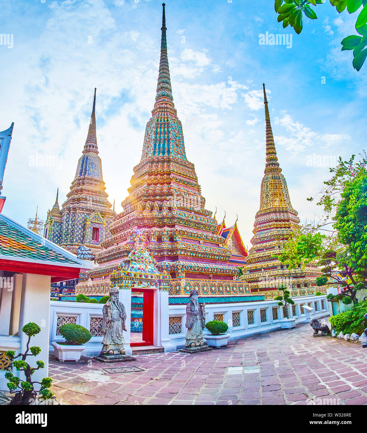 The scenic view on high pagodas of Phra Maha Chedi shrine, one of the most  famous part of Wat Pho complex, Bangkok, Thailand Stock Photo - Alamy