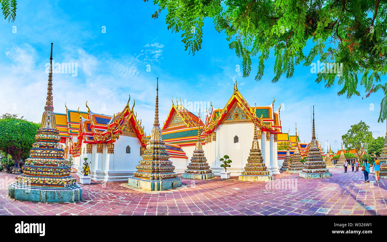 BANGKOK, THAILAND - APRIL 22, 2019: Panorama of colorful tiled arches of Phra Chedi Rai located at the perimeter of main Phra Ubosot shrine of Wat Pho Stock Photo