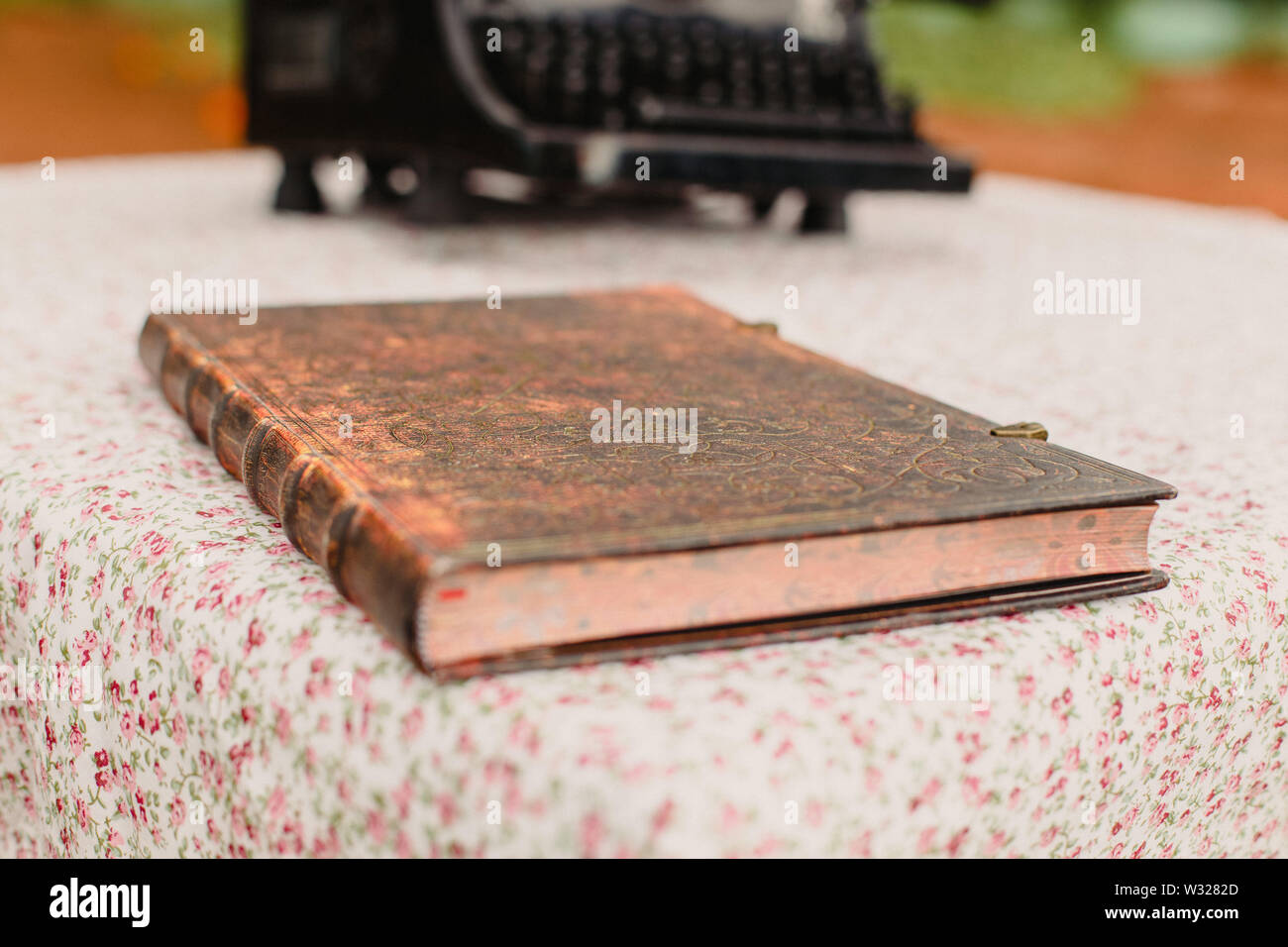Old book with leather covers on a vintage style table. Stock Photo