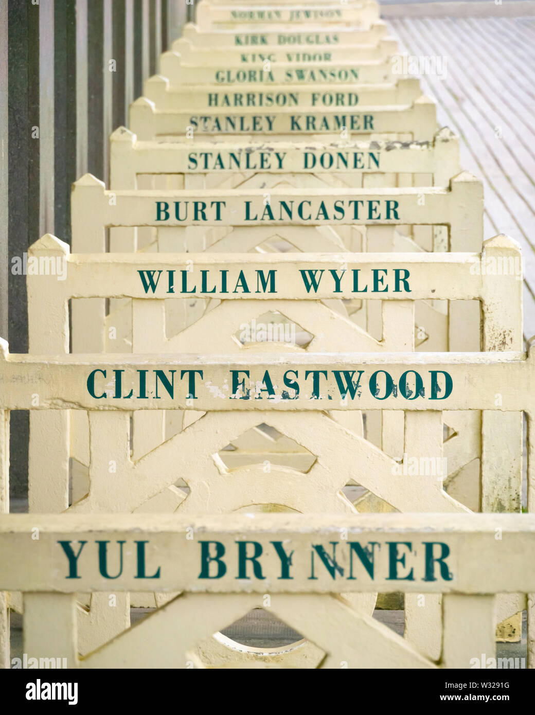 Beach closets barriers with the names of famous hollywood actors along the boardwalk Les Planches, Deauville, France. Stock Photo