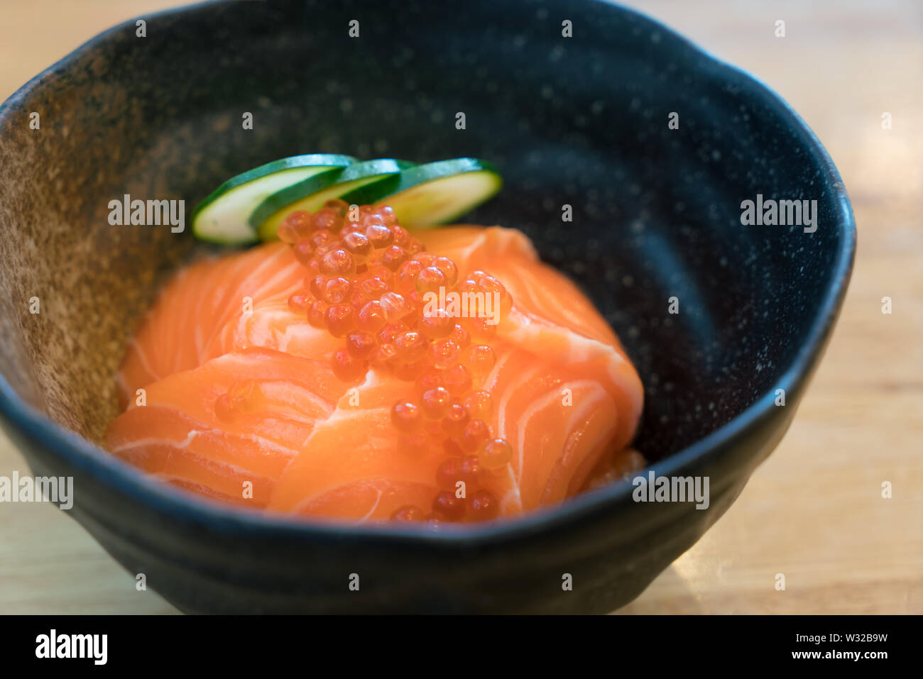 Salmon Ikura Don - Japanese cuisine, Salmon and Roe Rice Bowl in table at  Japanese food restaurant. Stock Photo