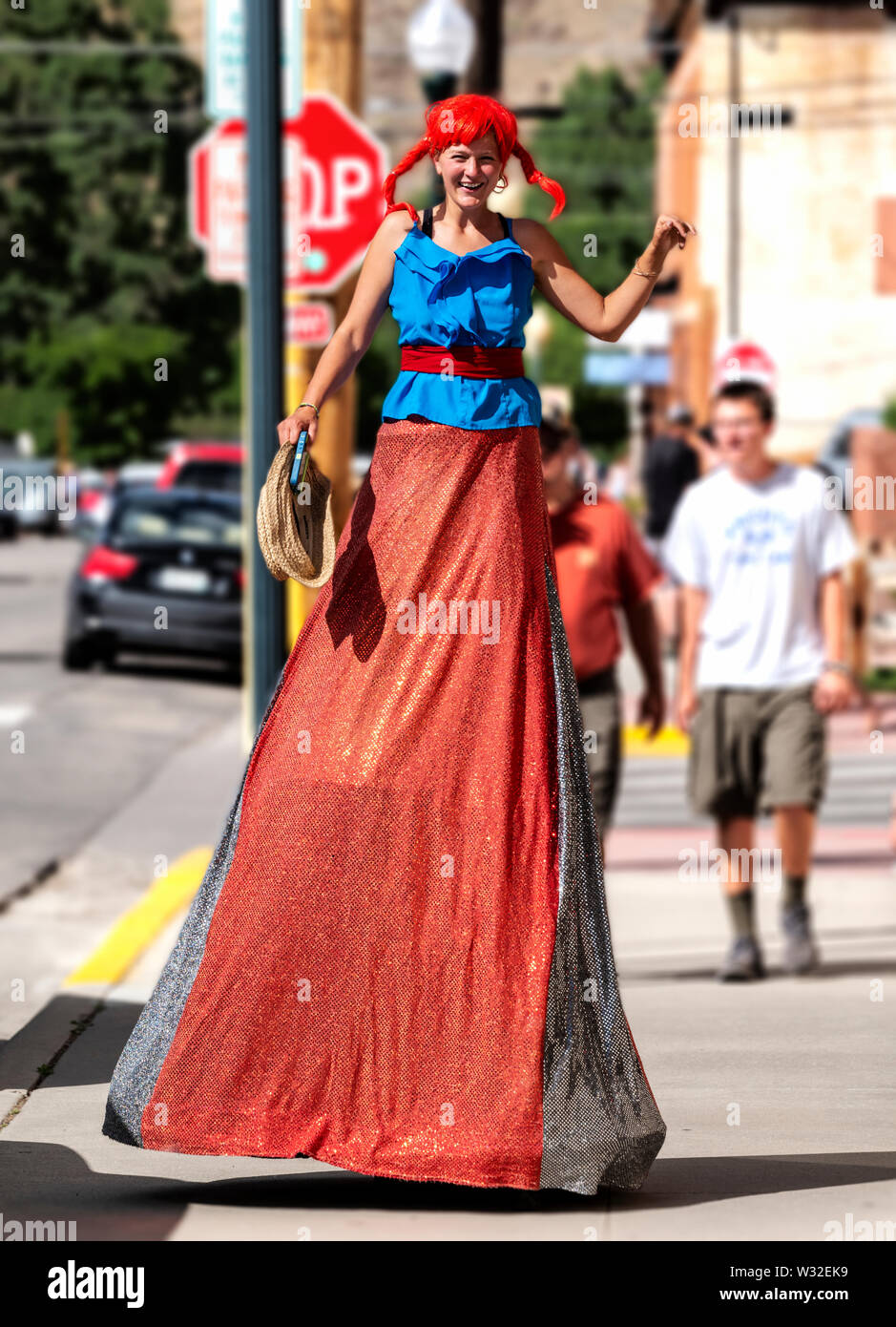 Salida Circus performer on stilts leaving annual Fourth of July Parade; small mountain town of Salida; Colorado; USA Stock Photo