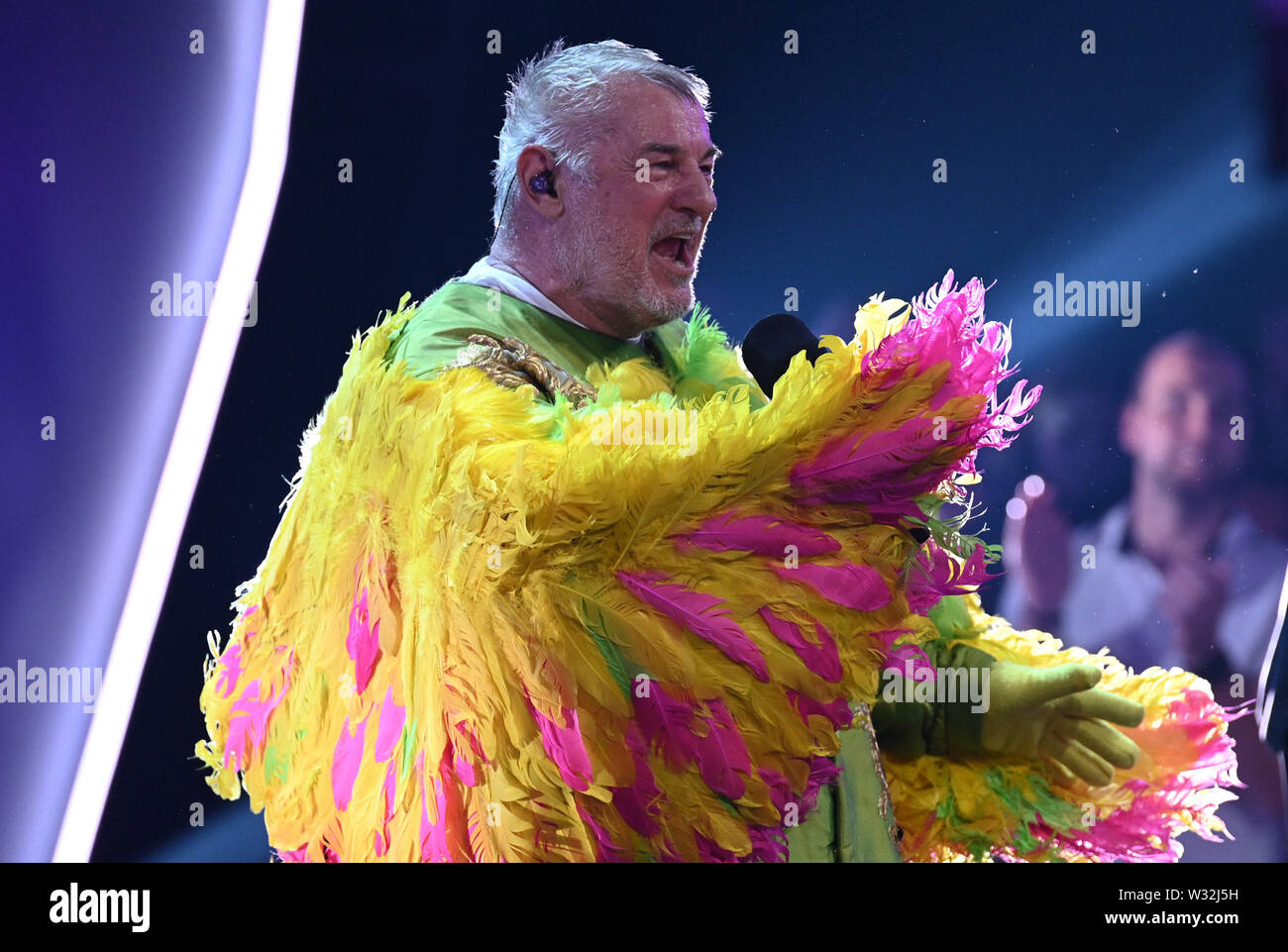 Cologne, Germany. 11th July, 2019. The actor Heinz Hoenig stands on stage  as "Kakadu" at the ProSieben show "The Masked Singer". Credit: Henning  Kaiser/dpa/Alamy Live News Stock Photo - Alamy