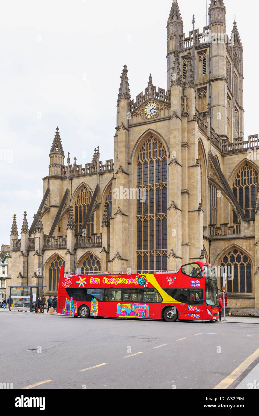 Large red open top double decker tourist tour bus for Bath City Sightseeing Tours parked outside Bath Abbey, Bath, Somerset, south-west England, UK Stock Photo