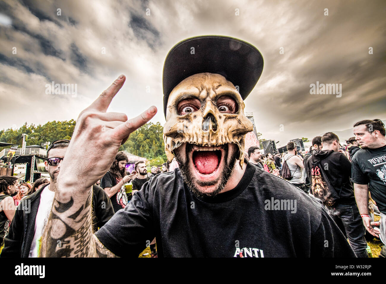 A metalhead with a skull mask during the Resurrection Fest music festival in Viveiro, northern Spain.Resurrection Fest is a music festival of extreme music, metal, hardcore, punk, stoner and doom. This was the 14th edition. It featured international bands like Slipknot, Slayer, Parkway Drive, Brant Bjork, Radio Moscow, Within Temptation, Lamb of God or King Diamond. Stock Photo