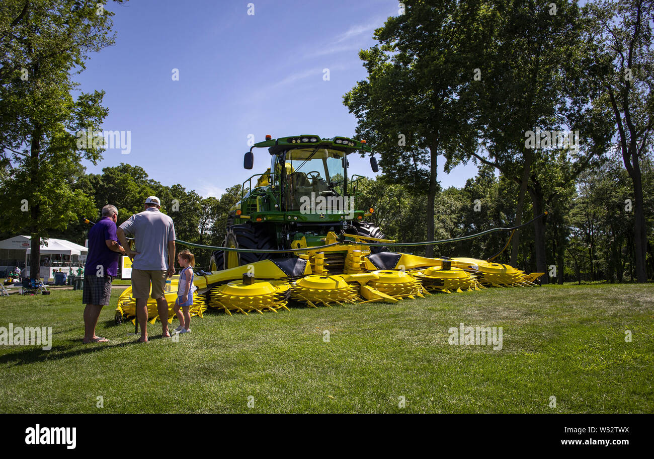 Silvis, Iowa, USA. 10th July, 2019. Attendees stop to look at a John