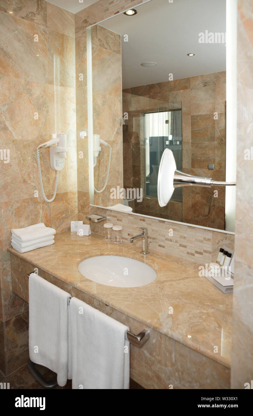 Bathroom in a hotel - marble basin and mirror Stock Photo - Alamy