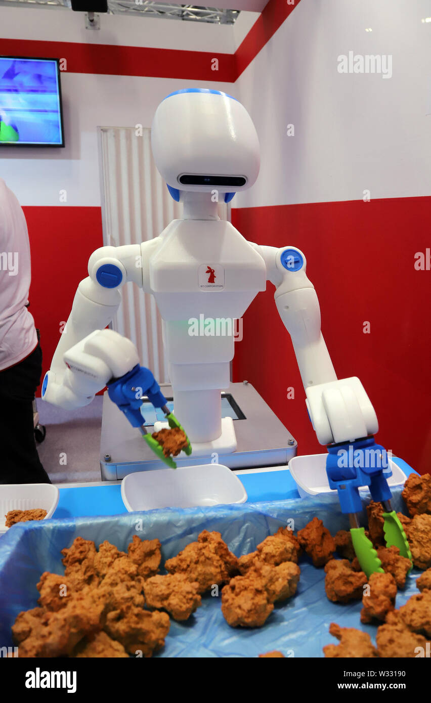 Tokyo, Japan. 11th July, 2019. Japanese robot venture RP corporation's  humanoid robot Foodly picks fried chickens for a demonstration of  collaboration work with robots and humans at the International Food  Machinery and
