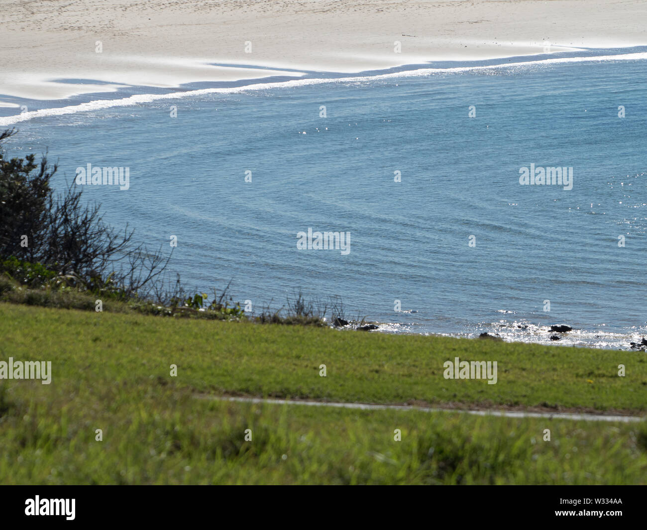 Circular ripples in the blue sea water at the sandy beach, view from ...