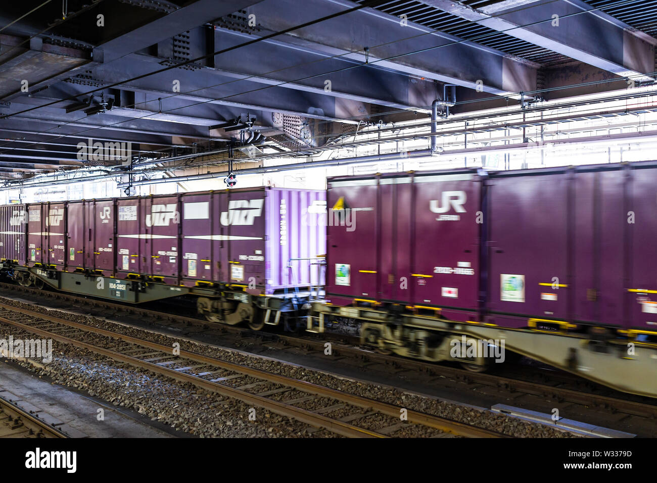 Utsunomiya, Japan - April 4, 2019: Industrial view of cargo freight train in Tochigi prefecture station with sign passing by platform Stock Photo