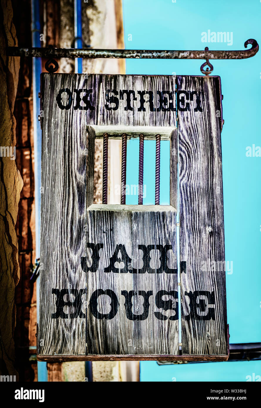 A handmade wooden sign hangs overhead the entrance to the OK Street Jailhouse, now a B and B in historic Bisbee, AZ, USA Stock Photo