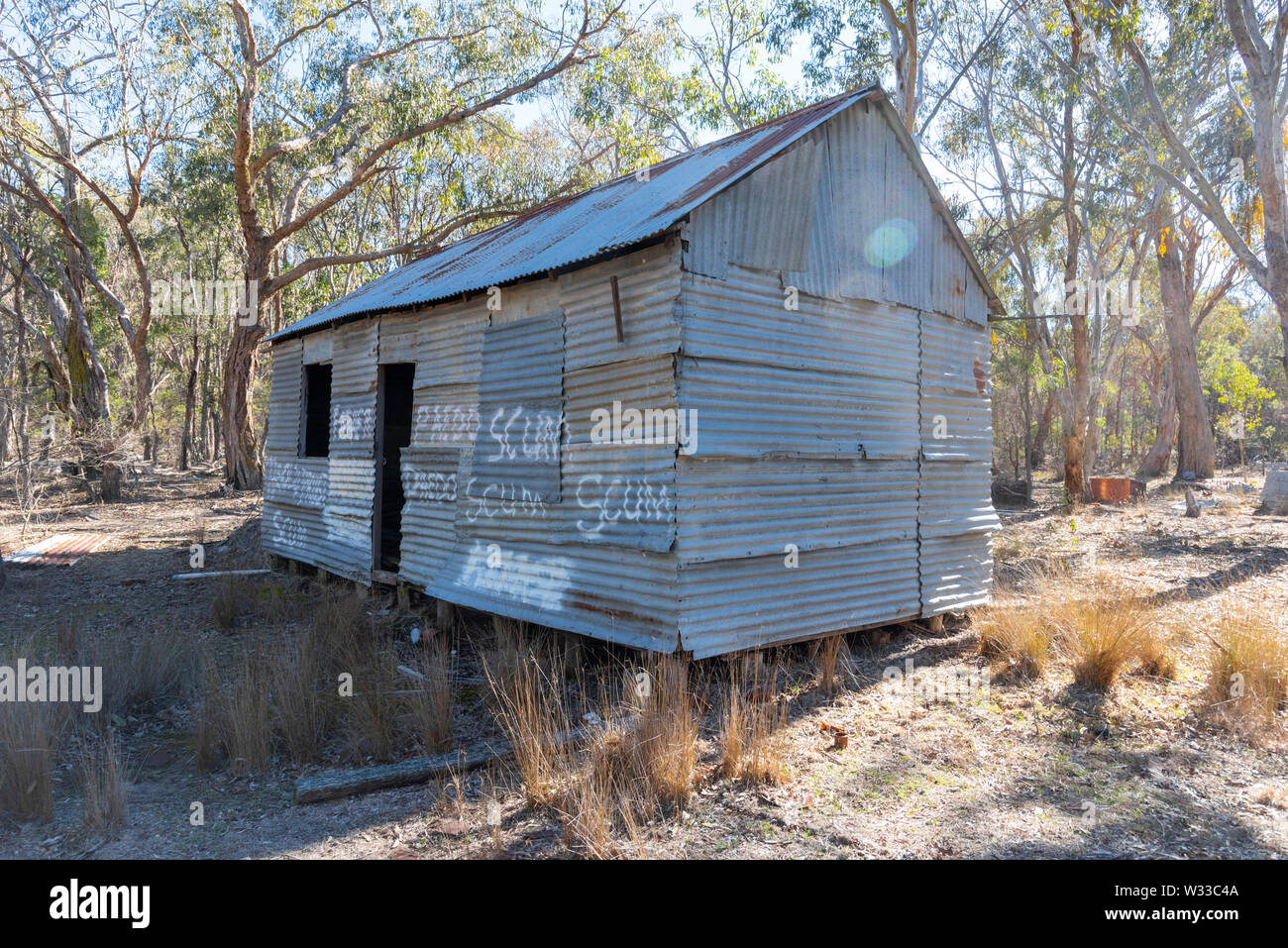 old derelict house outside Emmaville in northern new south wales, australia, with graffiti complaining about child abuse by an unknown old priest Stock Photo