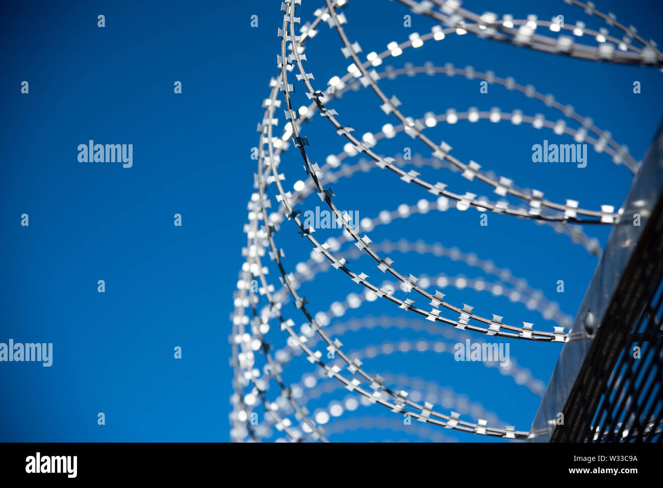 Science Behind Razor Wire razor wire atop a security fence with deep blue sky behind Stock Photo ...