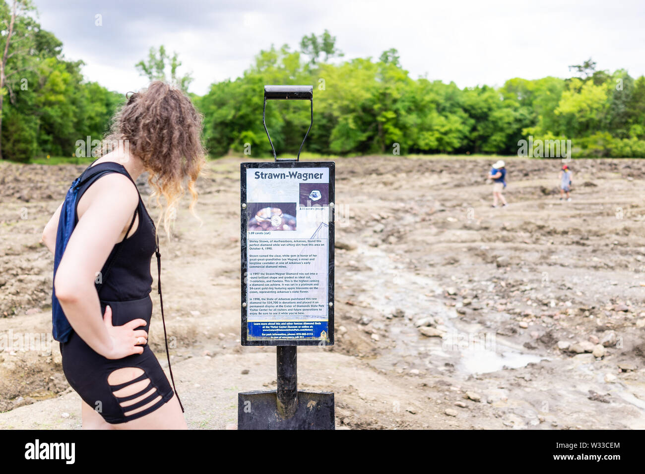 Murfreesboro, USA - June 5, 2019: Crater of Diamonds State Park in Arkansas with woman reading sign for historic Strawn-Wagner found diamond Stock Photo
