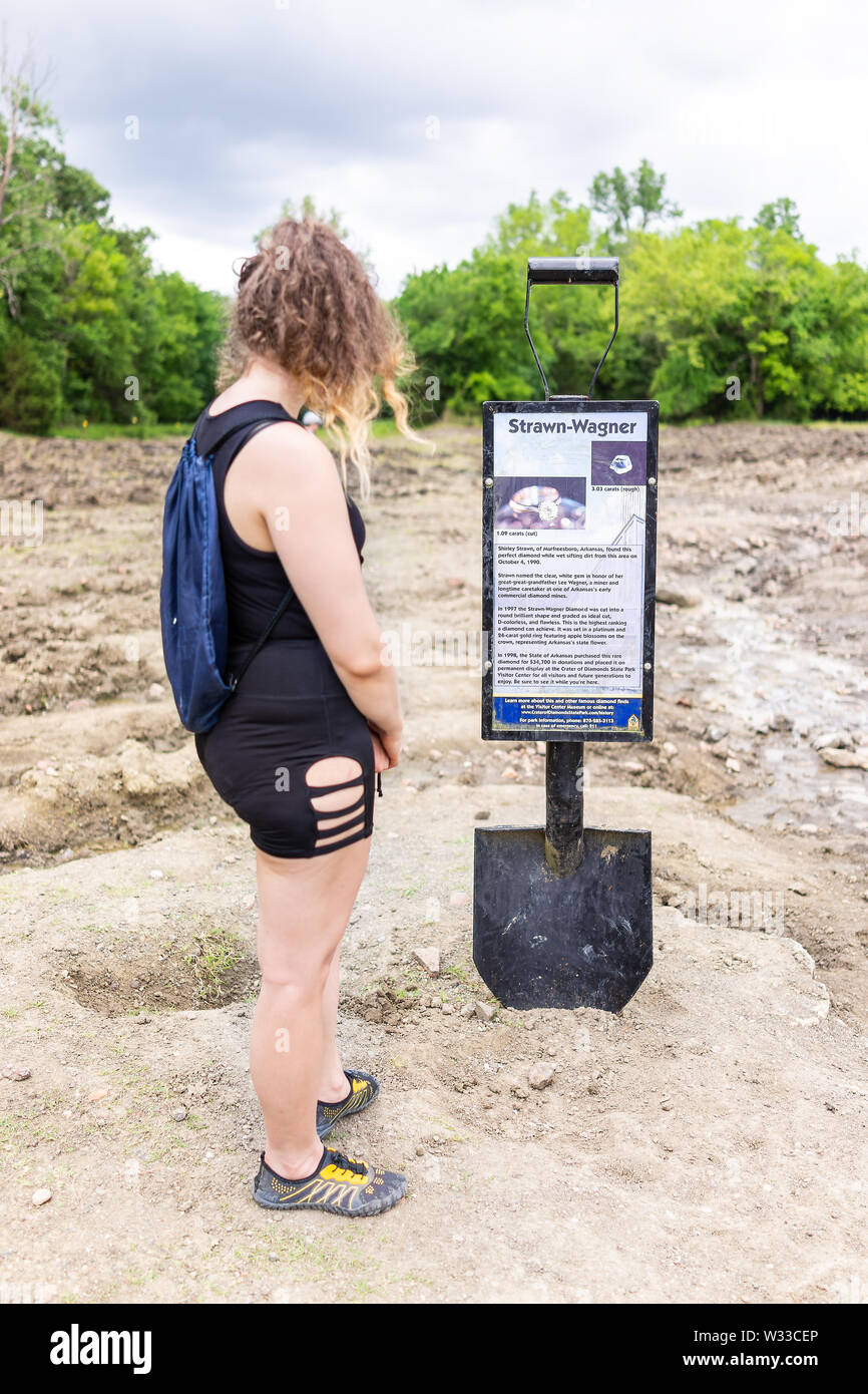 Murfreesboro, USA - June 5, 2019: Crater of Diamonds State Park in Arkansas with girl reading sign for historic Strawn-Wagner found diamond Stock Photo