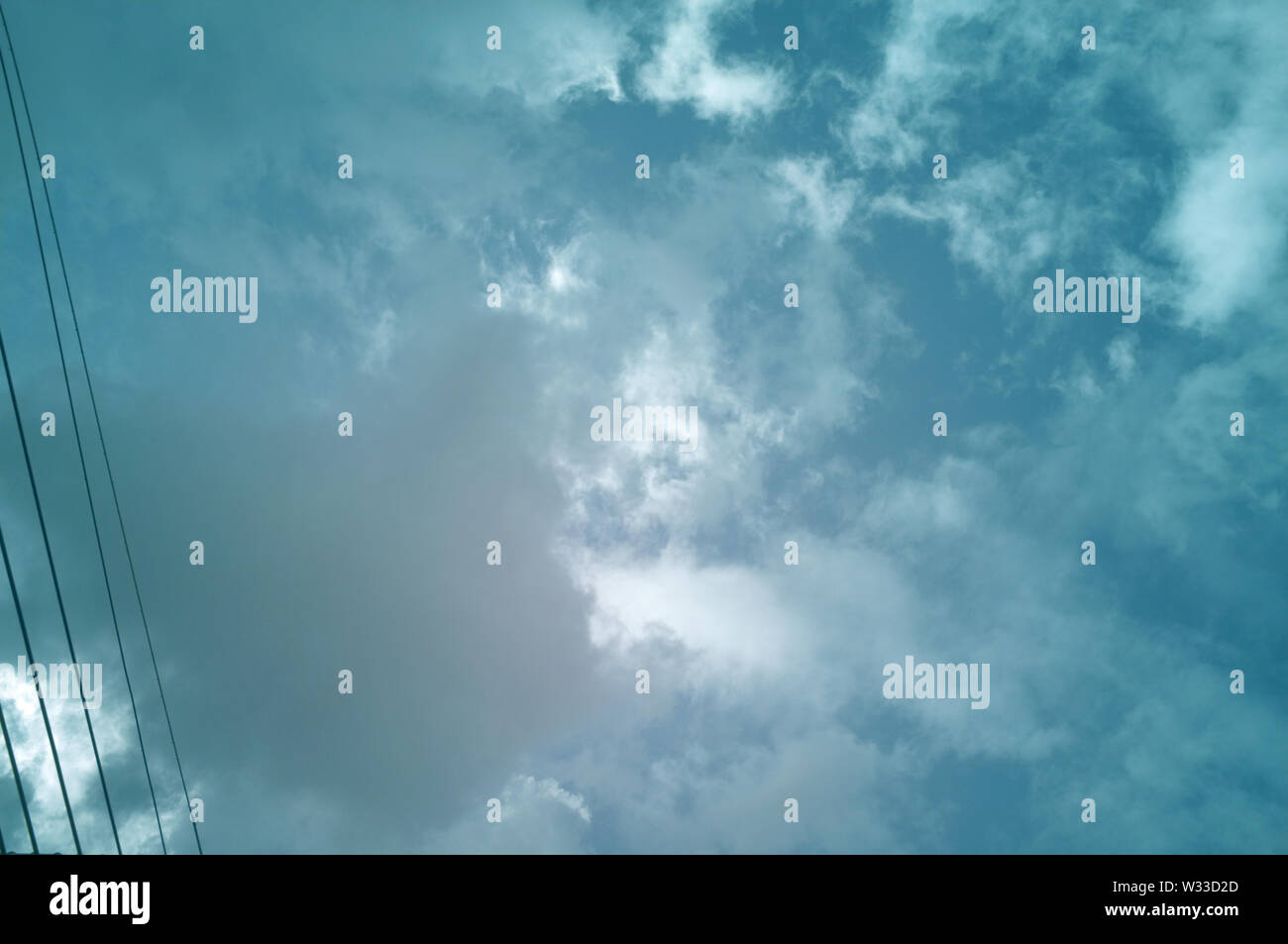Electric cable lines with blue sky background Stock Photo - Alamy