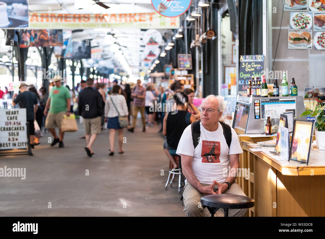 New Orleans, USA - April 23, 2018: Inside of old town French Quarter outdoor covered arcade food flea market in Louisiana city, people shopping eating Stock Photo