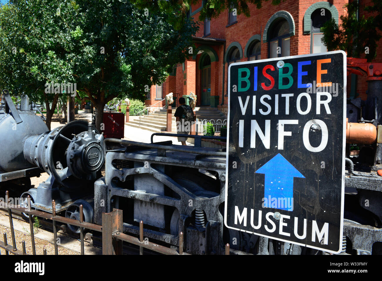 A sign for Bisbee Visitor Info and Bisbee Mining and Historical museum in small town America