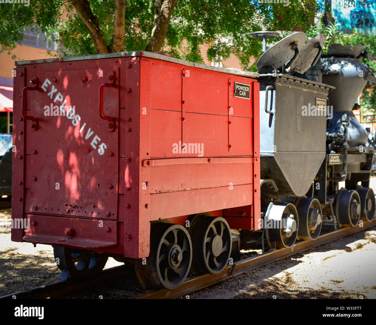 A vintage powder car, marked 'explosives' with other mining equipment in exhibit in front of the Bisbee Mining and Historical museum, Bisbee, AZ Stock Photo