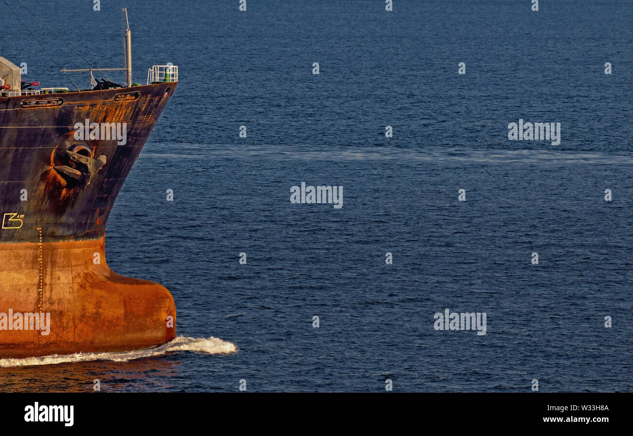 singapore strait, singapore - may 07, 2009: the bulbous bow of the empty products tanker new ambition (imo  8312538)  cutting the calm seas of singapo Stock Photo