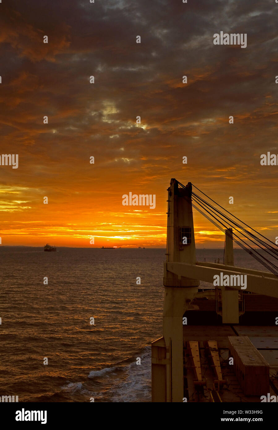 singapore strait, singapore - november 24, 2009: view onto a dramatic sunset over the waters of the singapore strait from the westbound multipurpose c Stock Photo