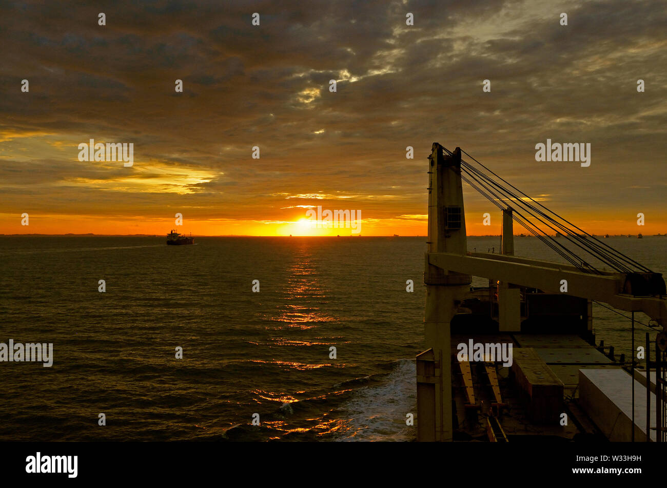 singapore strait, singapore - november 24, 2009: view onto a dramatic sunset over the waters of the singapore strait from the westbound multipurpose c Stock Photo