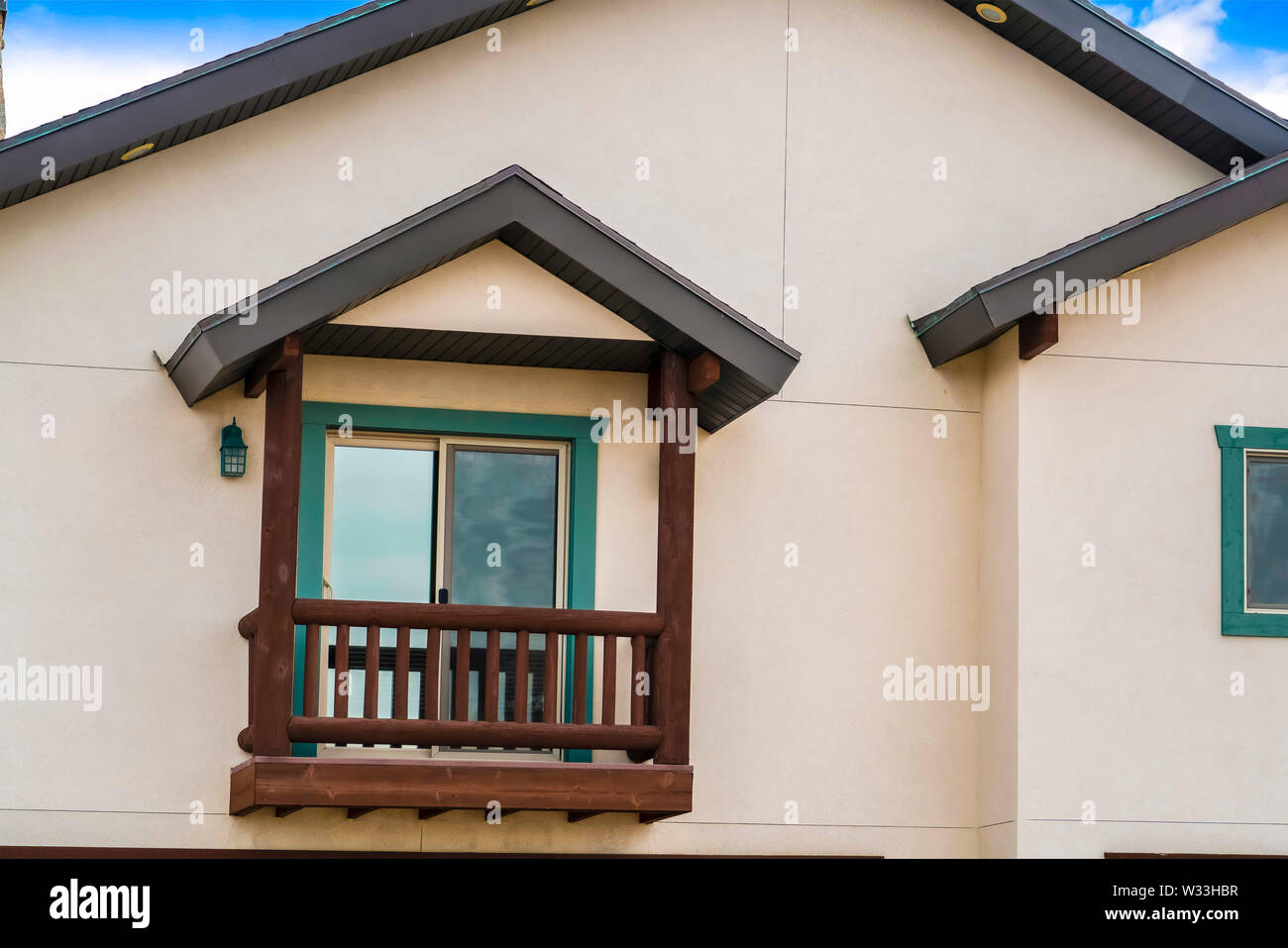 Small Balcony With Brown Wooden Railings And Posts Under A Pitched