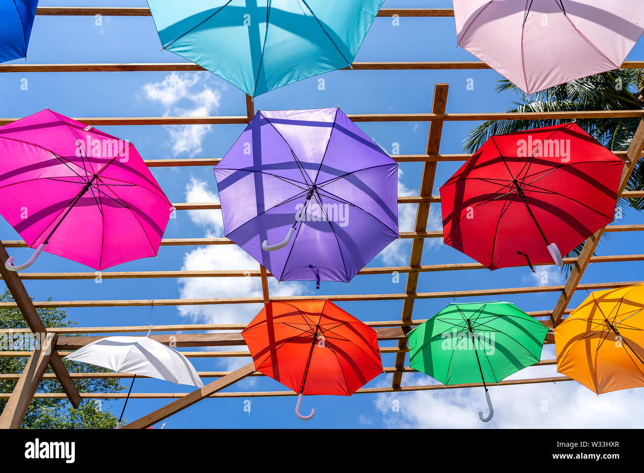 Street decorated with colored umbrellas, island Koh Phangan, Thailand. Hanging colorful umbrellas, on the outdoors Stock Photo
