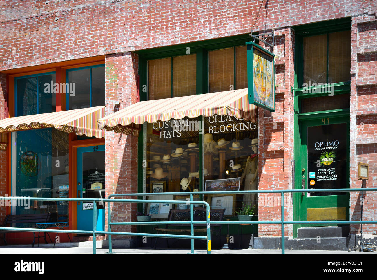 A bountiful display of hats in the storefront of Optimo, a charming