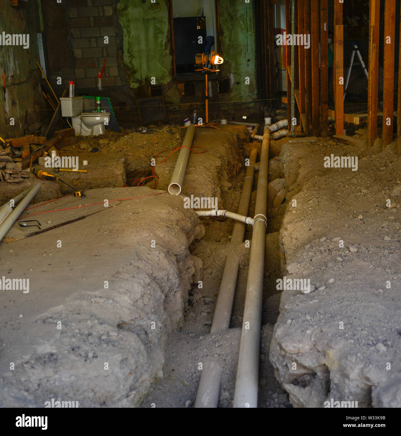A Trench Dug Up To Reveal Major Overhaul Of Plumbing System To Old House With Updates Of Pvc Piping In Small Town America Stock Photo Alamy