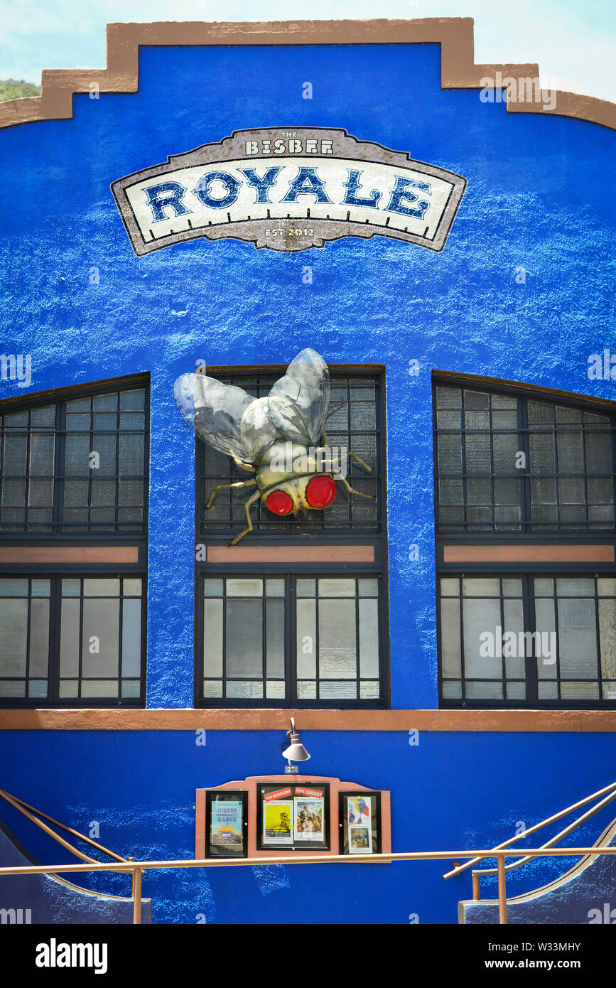 The entrance to Bisbee Royale, with a giant fly sculpture on window, a