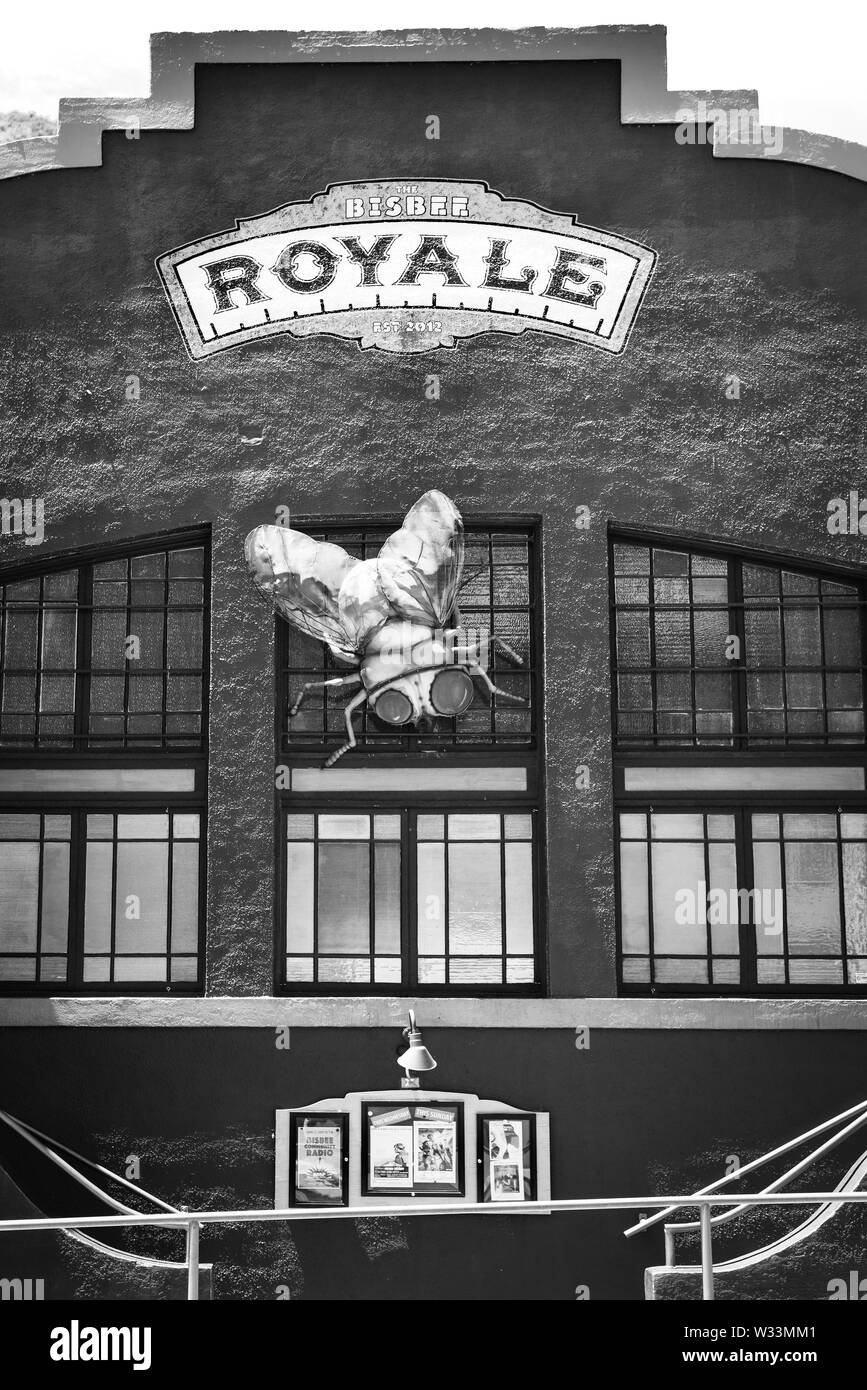 The entrance to Bisbee Royale, with a giant fly sculpture on window, a movie house and music venue  in the old mining town of Bisbee, AZ, USA, in blac Stock Photo