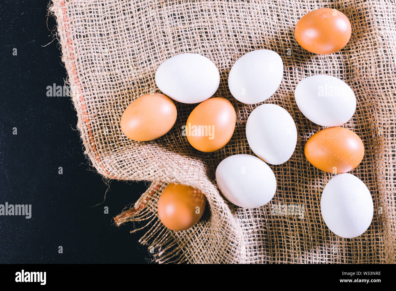 Eggs on tablecloth over black background Stock Photo