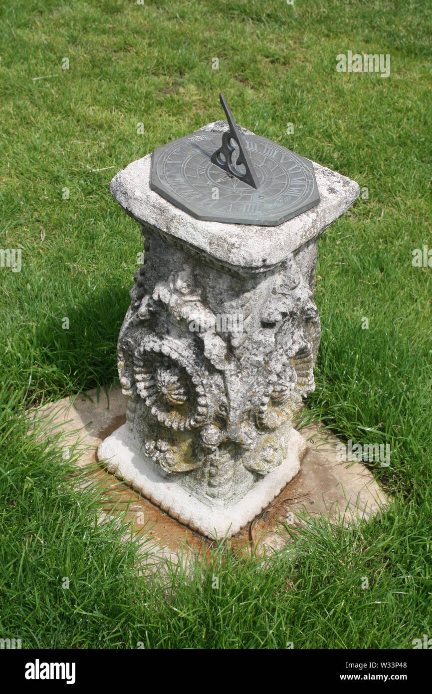 Garden sun dial on a stone column Stock Photo