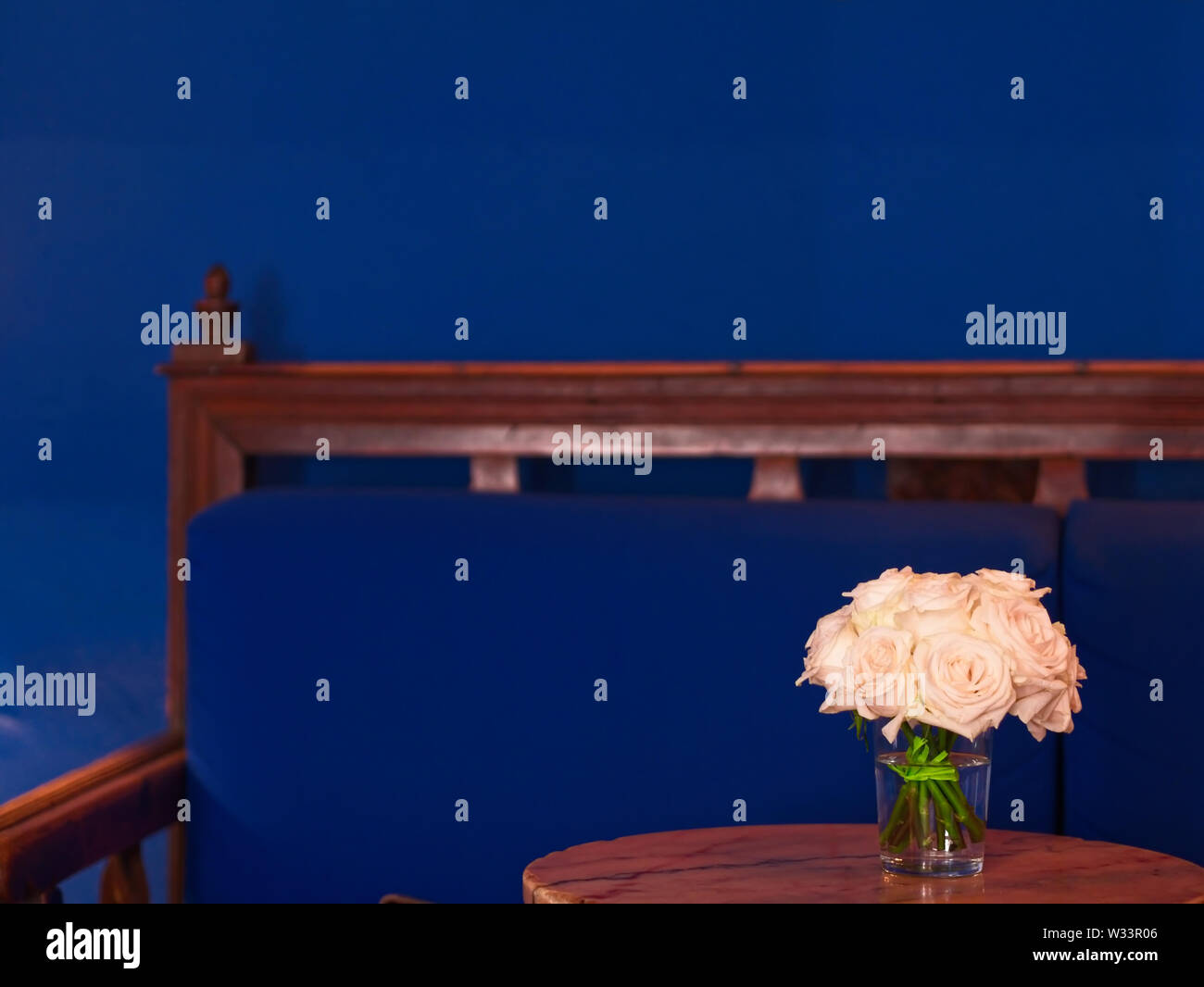 White Roses On A Wooden Table And Furniture Dark Blue Wall