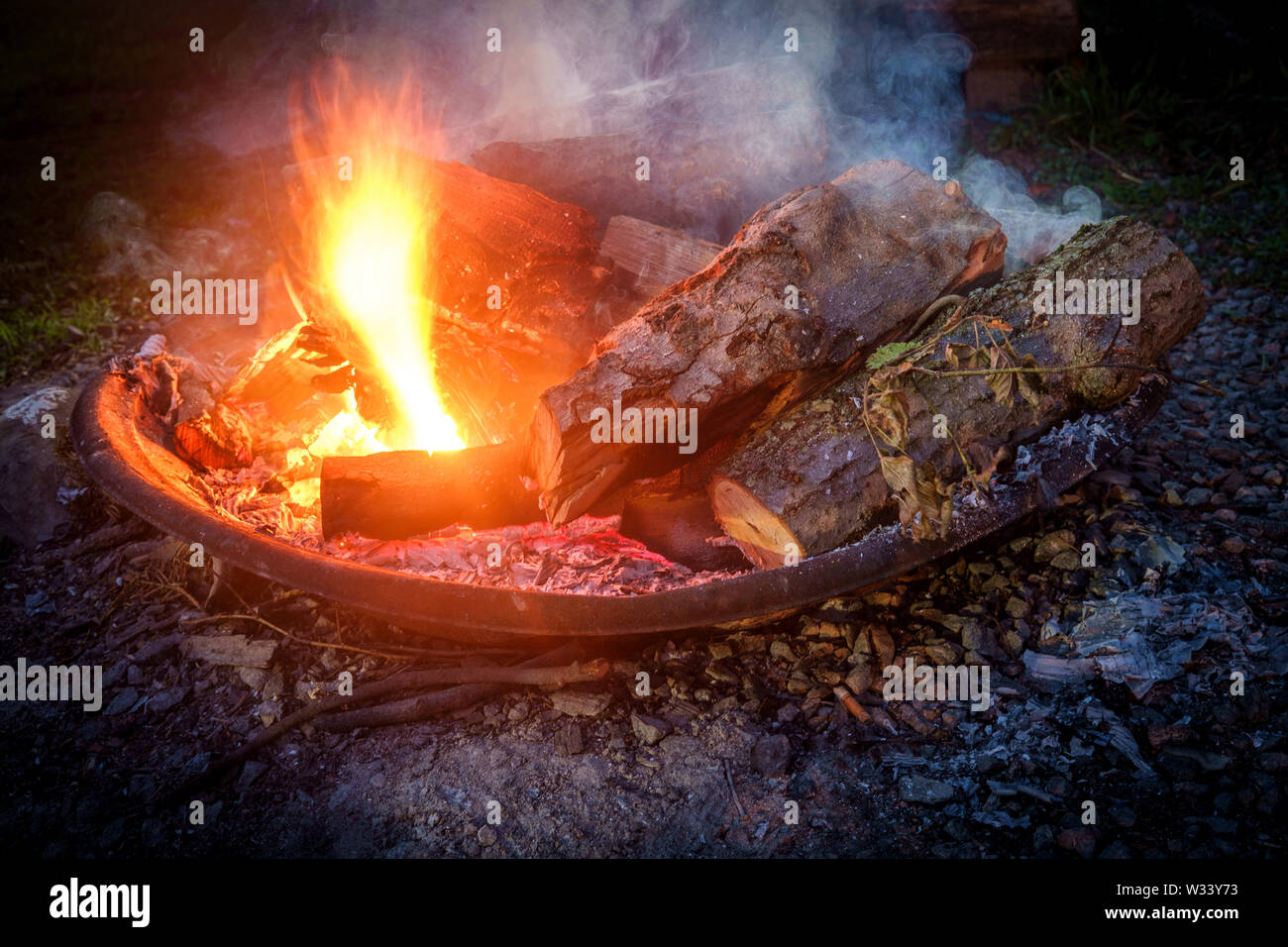 Summer camping fire pit with blue smoke Stock Photo Alamy