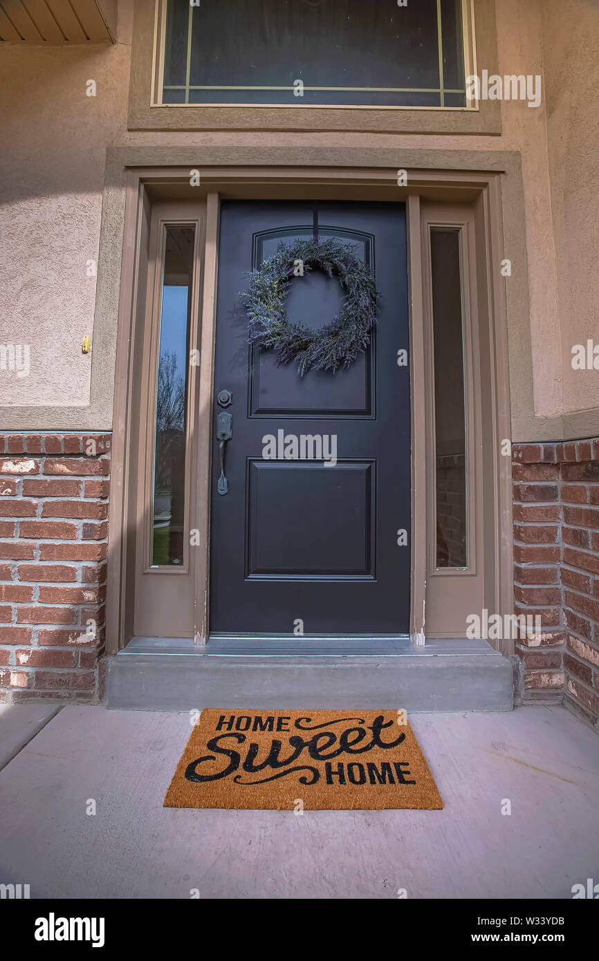 Wreath And Doormat On The Front Door With Sidelights And Transom
