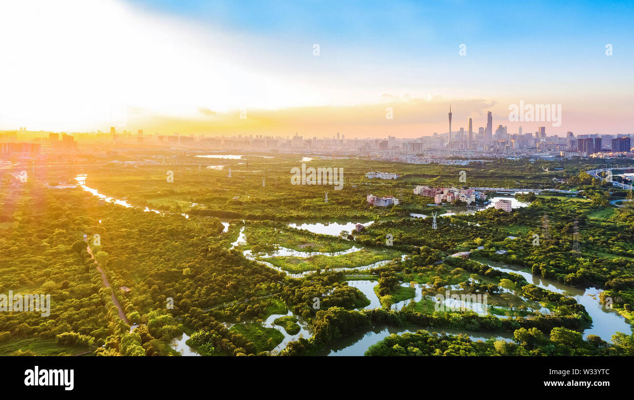 (190712) -- BEIJING, July 12, 2019 (Xinhua) -- Aerial photo taken on July 16, 2018 shows a panoramic view at the Haizhu wetland in Guangzhou, capital of south China's Guangdong Province. Located in south China, Guangdong Province faces the South China Sea and borders Hunan and Jiangxi provinces to the north. It boasts the well-known Pearl River Delta, which is composed of three upstream rivers and a large number of islands. Due to the climate, Guangdong is famous for a diversified ecological system and environment. In recent years, by upholding the principle of green development, Guangdong Stock Photo