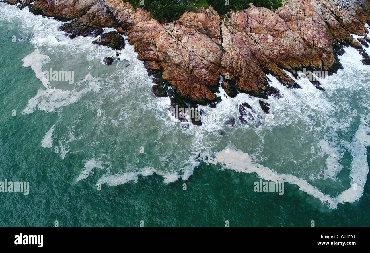 (190712) -- BEIJING, July 12, 2019 (Xinhua) -- Aerial photo taken on July 24, 2018 shows a view of the Nan'ao Island in south China's Guangdong Province. Located in south China, Guangdong Province faces the South China Sea and borders Hunan and Jiangxi provinces to the north. It boasts the well-known Pearl River Delta, which is composed of three upstream rivers and a large number of islands. Due to the climate, Guangdong is famous for a diversified ecological system and environment. In recent years, by upholding the principle of green development, Guangdong has made remarkable achievements Stock Photo