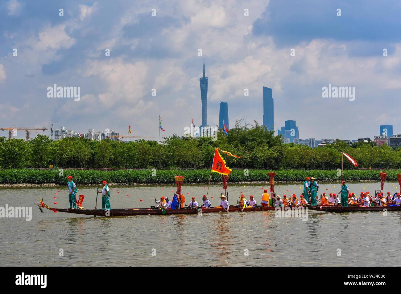 (190712) -- BEIJING, July 12, 2019 (Xinhua) -- Participants compete in a dragon boat race near the Haizhu wetland in Guangzhou, capital of south China's Guangdong Province, June 6, 2019. Located in south China, Guangdong Province faces the South China Sea and borders Hunan and Jiangxi provinces to the north. It boasts the well-known Pearl River Delta, which is composed of three upstream rivers and a large number of islands. Due to the climate, Guangdong is famous for a diversified ecological system and environment. In recent years, by upholding the principle of green development, Guangdong Stock Photo