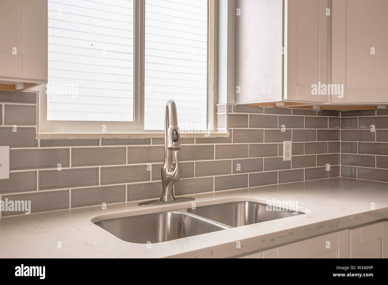 Undermount Double Bowl Sink And Faucet On The Gleaming White