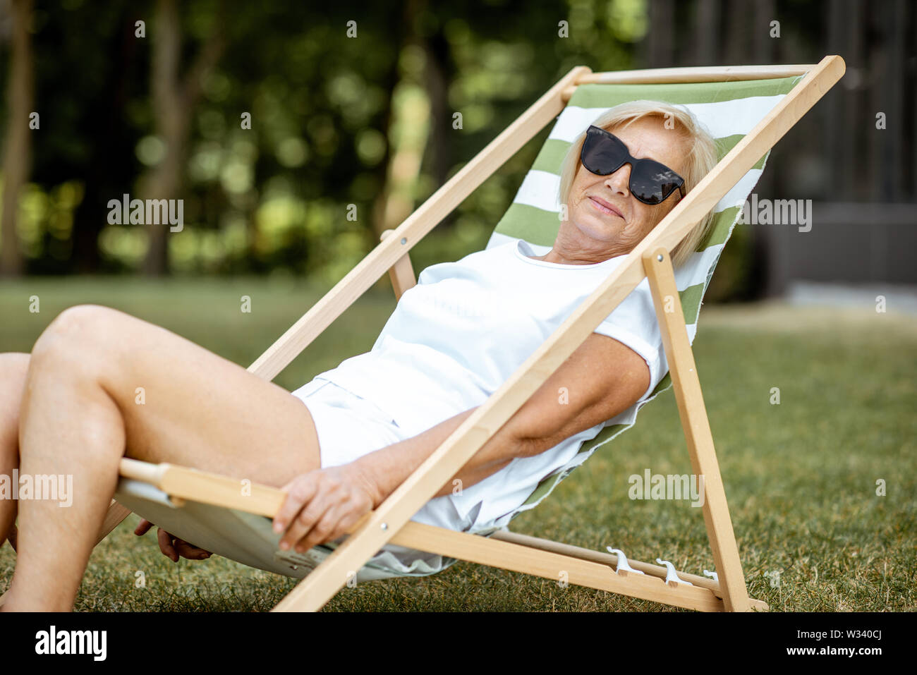 Carefree mature woman sunbathing hi-res stock photography and images ...