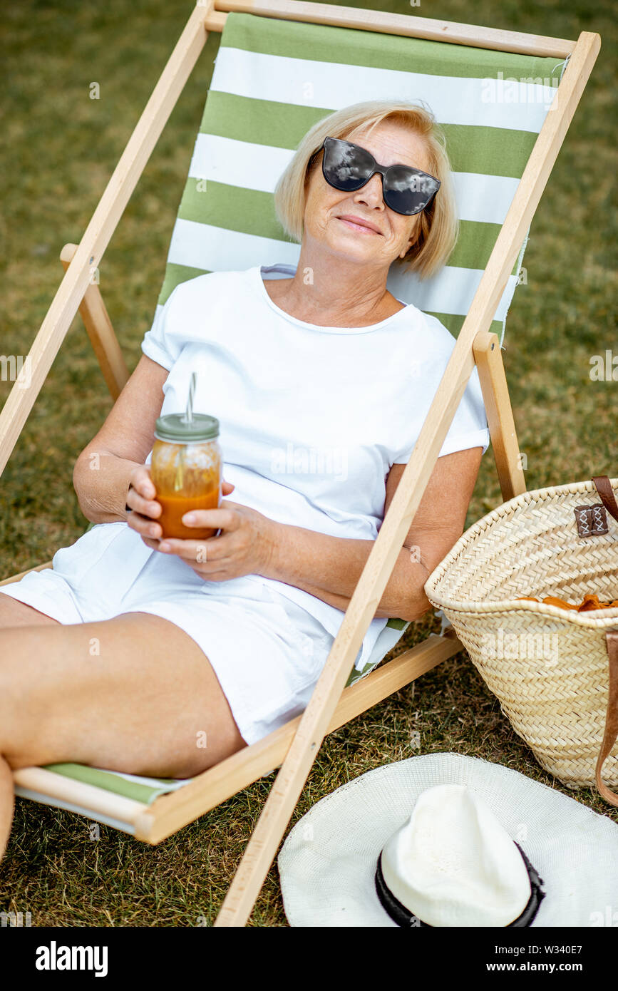 Carefree mature woman sunbathing hi-res stock photography and images ...