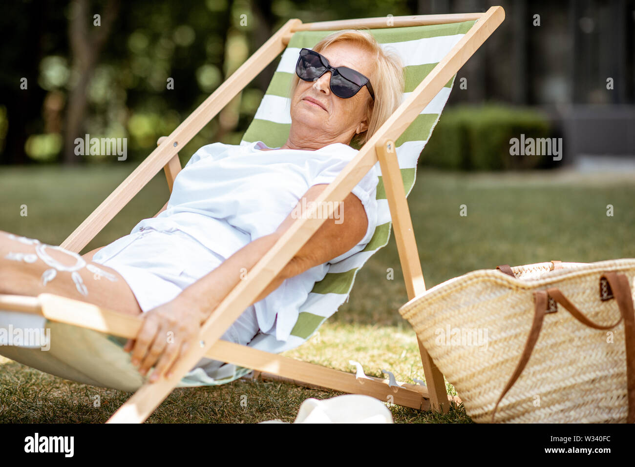 Carefree mature woman sunbathing hi-res stock photography and images ...