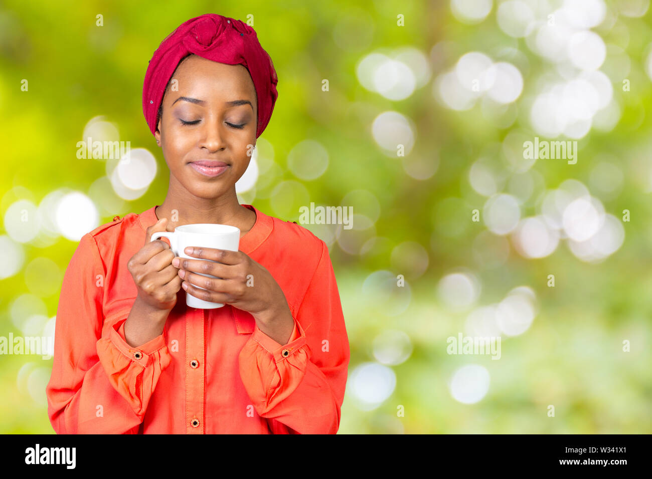 happy african american woman drinking tea cup or mug Stock Photo - Alamy