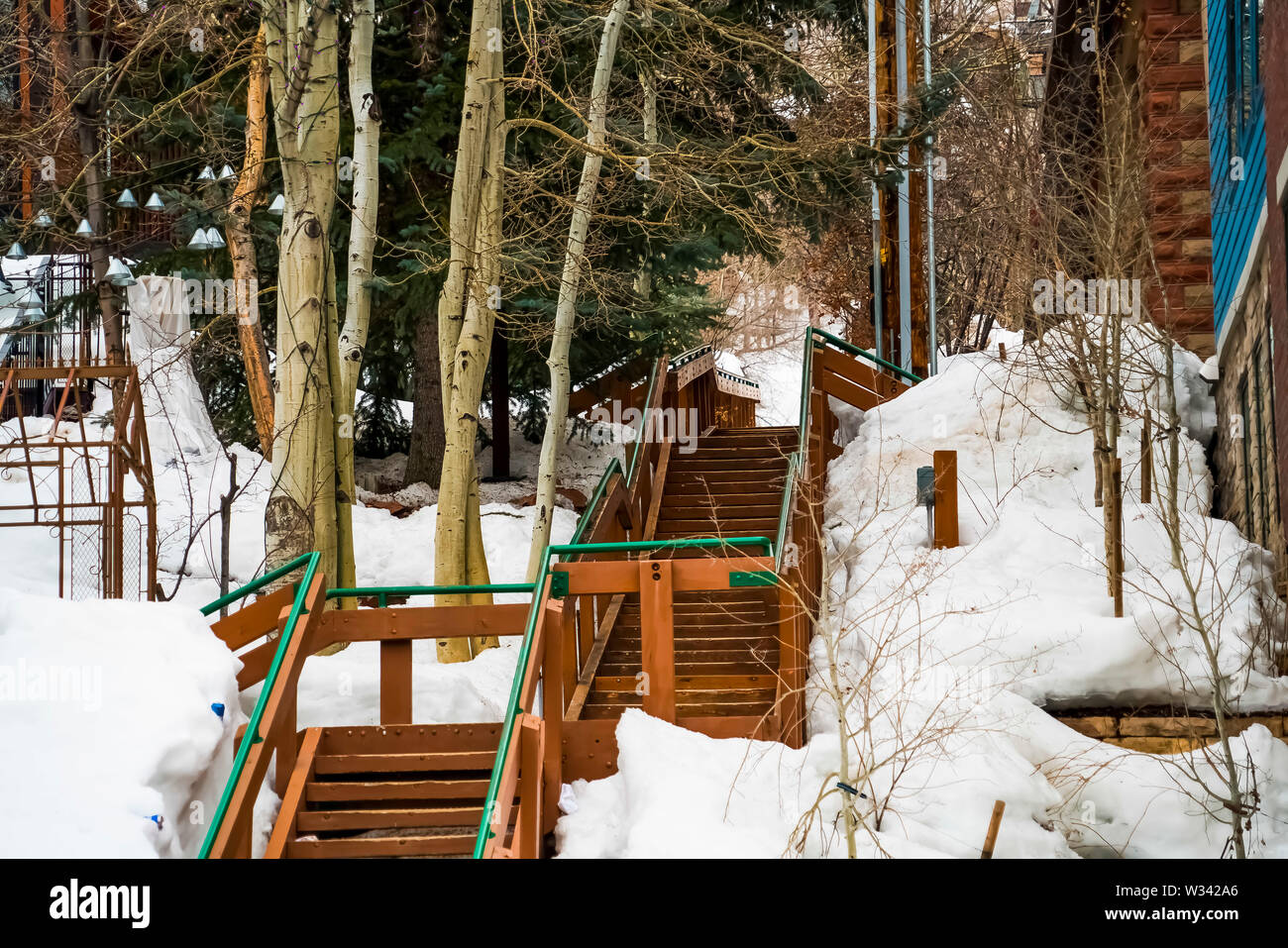 Snowy Ramp With Steps Outdoor stairs on a mountain slope covered with snow during winter ...