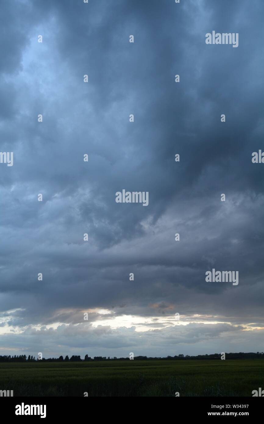 Rolling clouds  at dusk heavy and mixing a strange pattern in the sky. Stock Photo
